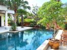 Outdoor pool area with adjacent seating and greenery