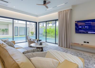 Modern living room with large windows and pool view