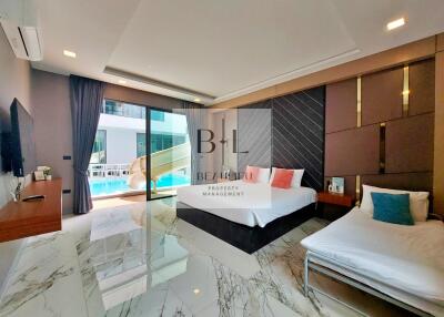 Modern bedroom with marble flooring, double bed, single bed, and pool view