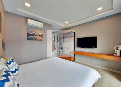 Modern bedroom with wall-mounted TV and air conditioning