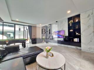 Modern living room with pool table and entertainment center