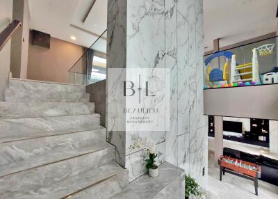 Modern home with a marble staircase and open play area