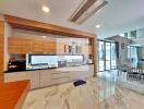 Modern kitchen with wooden and white cabinets, marble flooring, and dining area