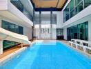 Indoor pool area with a slide and seating