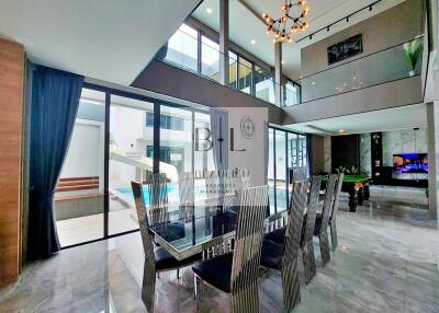 Modern dining room with large windows and view of the pool