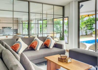 Modern living room with large windows and view of pool