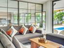 Modern living room with large windows and view of pool