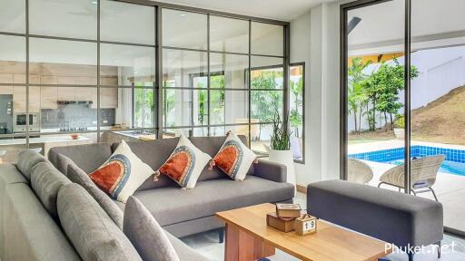 Modern living room with large windows and view of pool