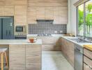 Modern kitchen with wooden cabinetry, island with seating, and large window