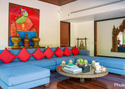 Modern living room with blue sectional sofa and colorful artwork