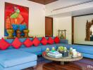 Modern living room with blue sectional sofa and colorful artwork