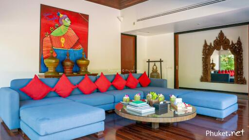 Modern living room with blue sectional sofa and colorful artwork