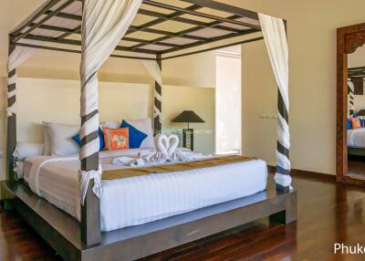 Spacious bedroom with a four-poster bed and modern decor