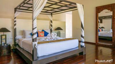 Spacious bedroom with a four-poster bed and modern decor