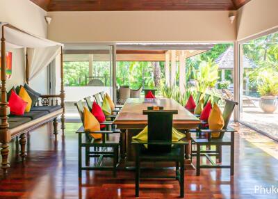 Spacious dining room with pool view and colorful pillows