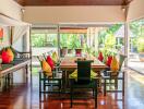 Spacious dining room with pool view and colorful pillows