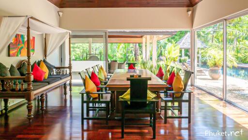 Spacious dining room with pool view and colorful pillows