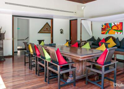 Dining area with colorful cushions and wooden table