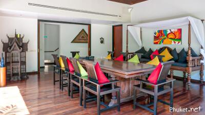 Dining area with colorful cushions and wooden table