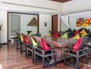 Dining area with colorful cushions and wooden table