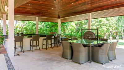 Spacious covered outdoor seating and dining area with bar