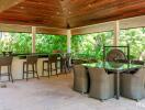 Spacious covered outdoor seating and dining area with bar