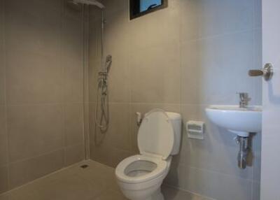 Modern bathroom with toilet, shower, and sink