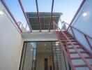 Outdoor staircase to the upper level with ceiling and lights