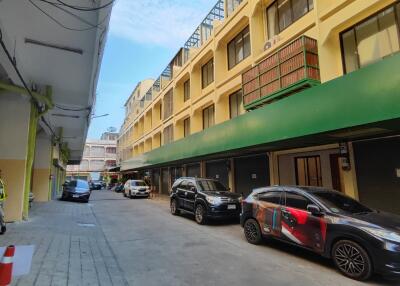 Exterior view of a multi-story building with parked cars