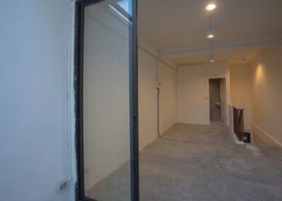 Empty indoor space with doorway and visible skylight