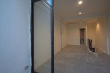 Empty indoor space with doorway and visible skylight