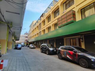 Exterior view of an apartment building with parked cars