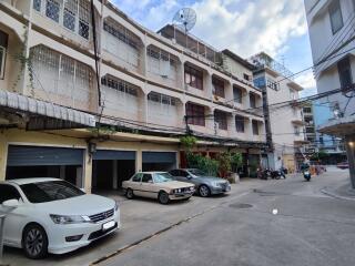 Exterior view of residential buildings with parked cars