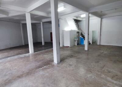 Spacious open area in a building with concrete floor and pillars