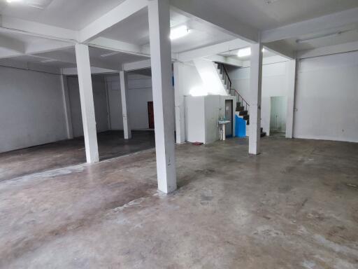 Spacious open area in a building with concrete floor and pillars