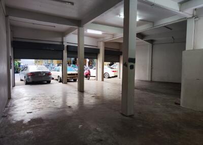 Semi-open parking garage with cars parked inside and outside