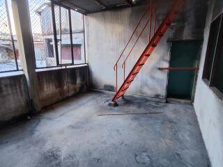 Warehouse with a stairway and metal fence