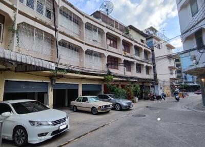 Exterior view of residential building with cars parked in front