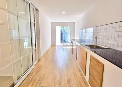Modern kitchen with wooden flooring and sleek design