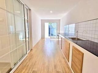 Modern kitchen with wooden flooring and sleek design