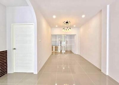 Bright hallway with tiled floor and modern lighting