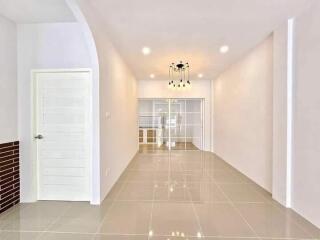 Bright hallway with tiled floor and modern lighting