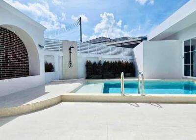 Outdoor swimming pool area with a modern design and clear sky