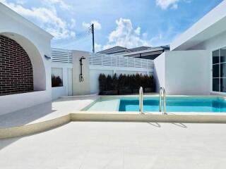 Outdoor swimming pool area with a modern design and clear sky