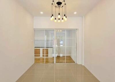 Modern living room with chandelier lighting and glass sliding doors