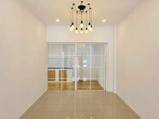 Modern living room with chandelier lighting and glass sliding doors