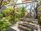 Beautiful greenery-filled garden with a wooden picnic table