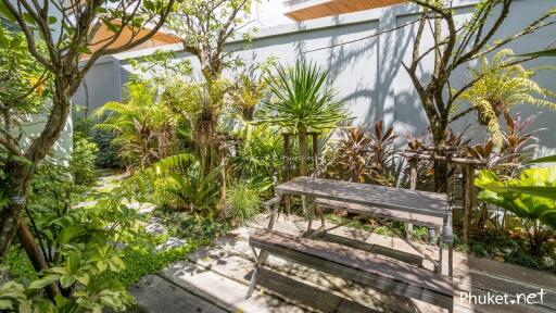 Beautiful greenery-filled garden with a wooden picnic table