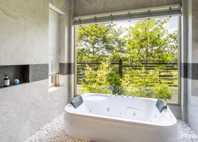 Modern bathroom with large window and jacuzzi tub