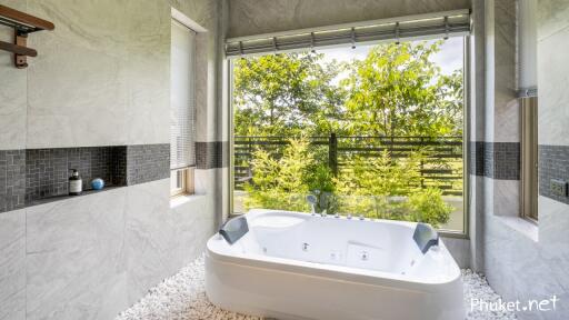 Modern bathroom with large window and jacuzzi tub